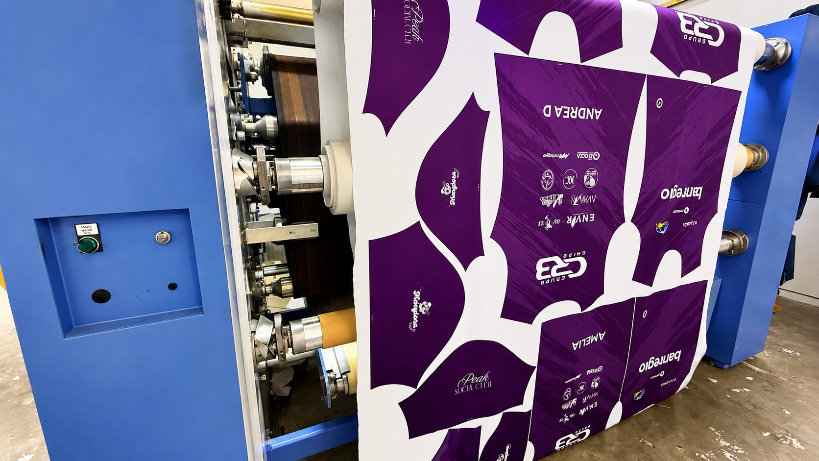 Blue industrial machinery with purple and white branded panels on display, showing mechanical components and internal mechanisms