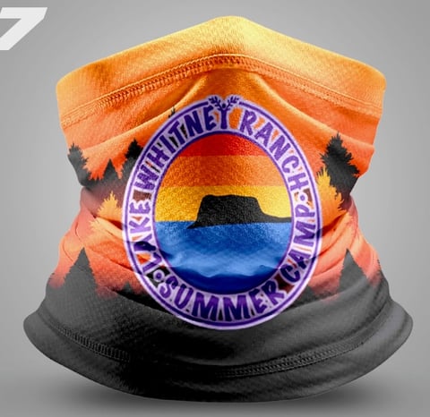 Neck gaiter featuring sunset landscape with circular purple badge and text design on orange and black fabric